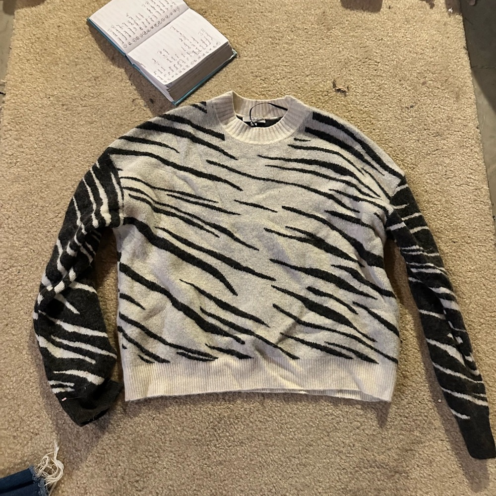 White and grey “tiger” stripped sweater.